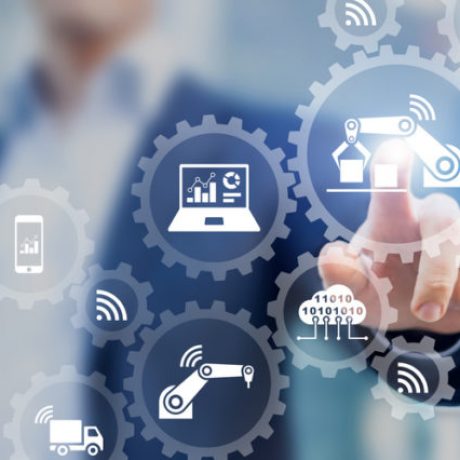 Smart factory and industry 4.0 concept with connected production robots exchanging data with internet of things (IoT) and cloud computing technology, businessman touching interface with icons in gears